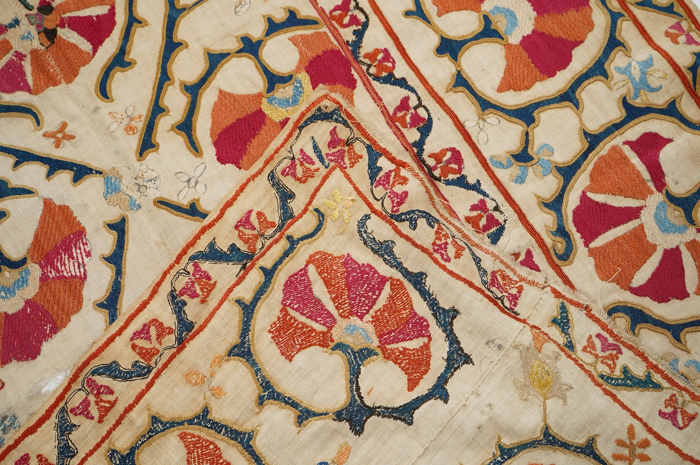 A 19th century Uzbekistan Suzani, hand embroidered hanging. Made from hand woven linen panels each approximately 28cm wide x 167cm long. Hand embroidered with silk hand dyed threads, in orange, red, blue and yellows, usi